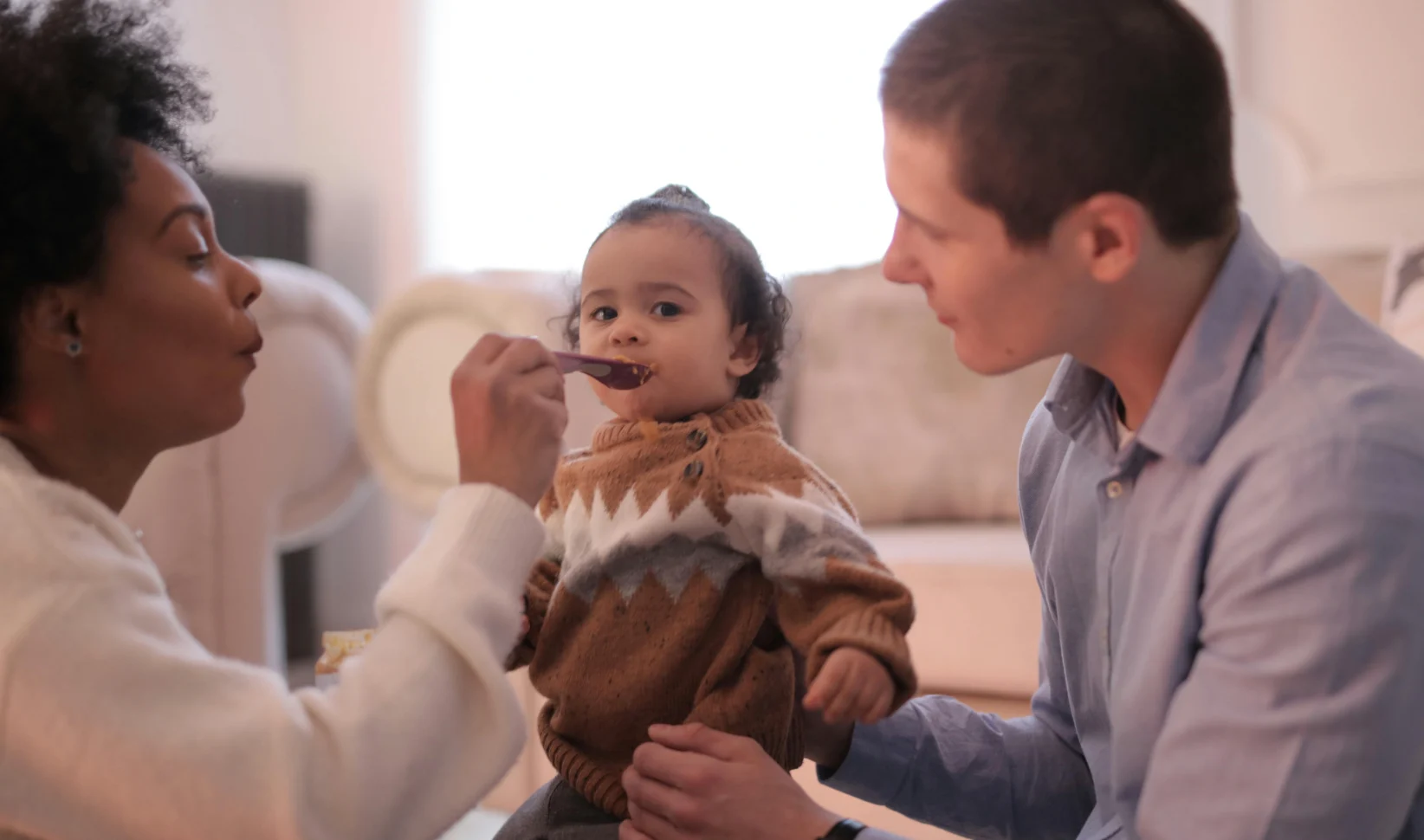 Familie geeft kind te eten Babyvoeding